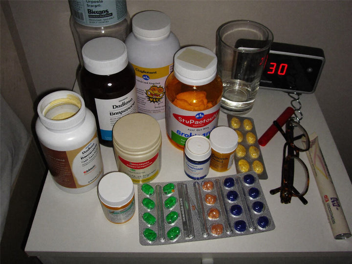 My actual nightstand, photographed the week I gave up. I counted eleven products. — Tom